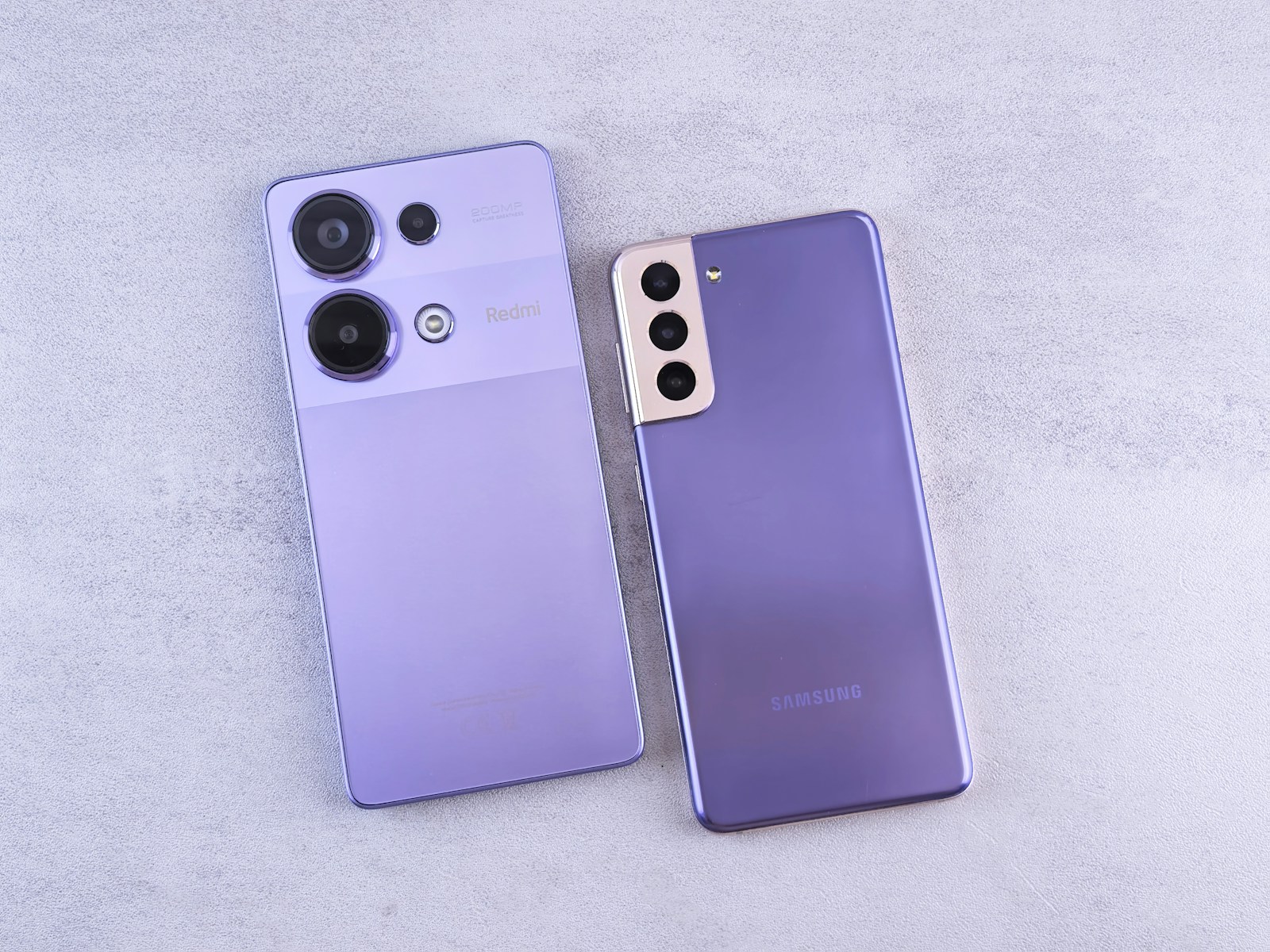 Two purple cell phones sitting next to each other